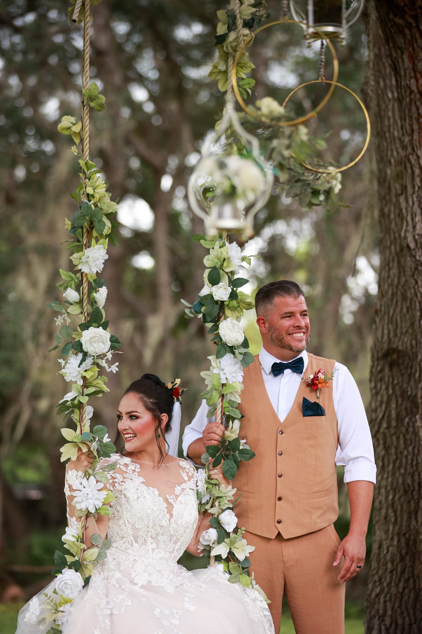 Wedding couple under a floral chandelier, cinematic film moment